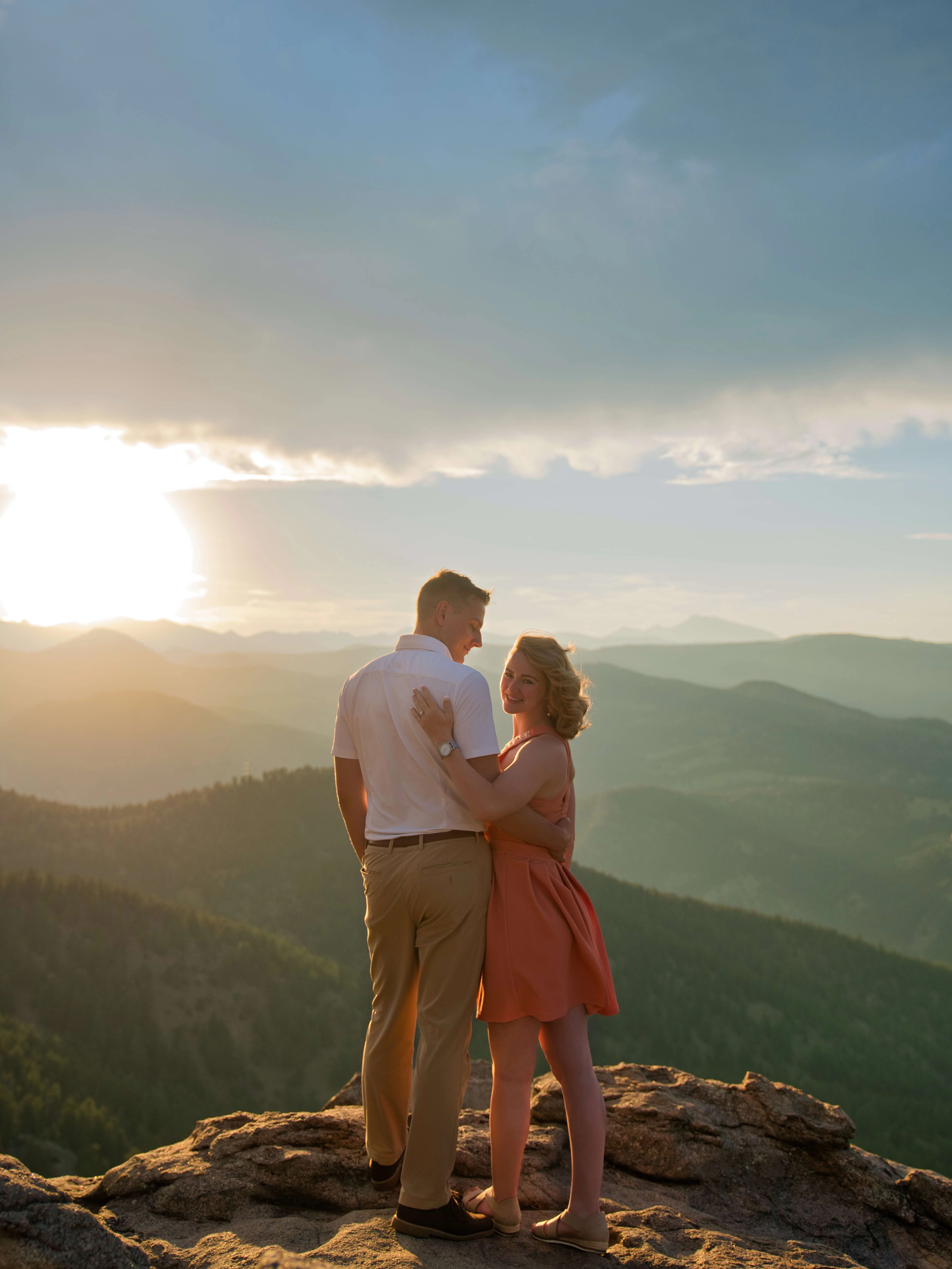 Denver Engagement Photographer – Rocky Mountain Views Engaged couple sharing intimate moment at sunset on Colorado mountain peak